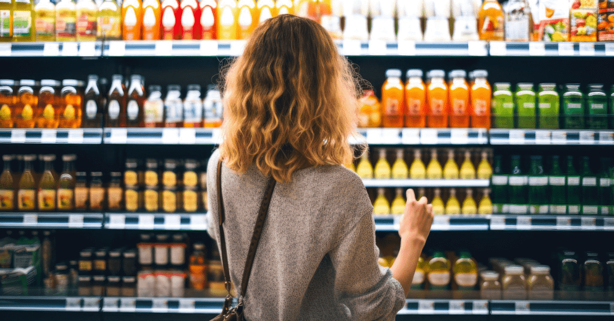 Lady picking a product off a supermarket shelf