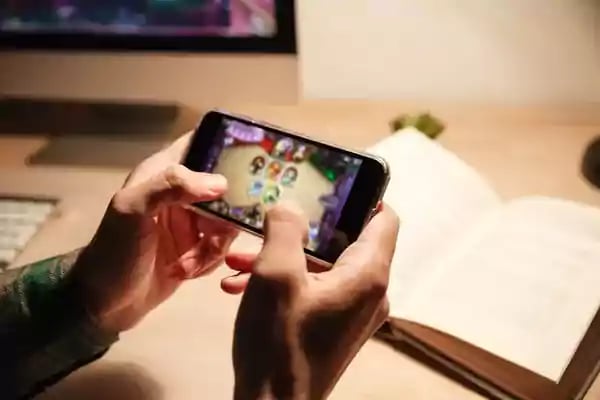 Playing a game on a mobile phone.