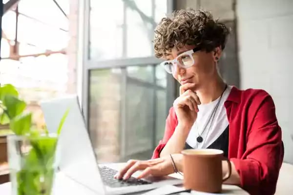 Woman typing on a laptop.