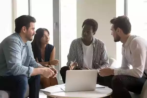 Group meeting around a small table.