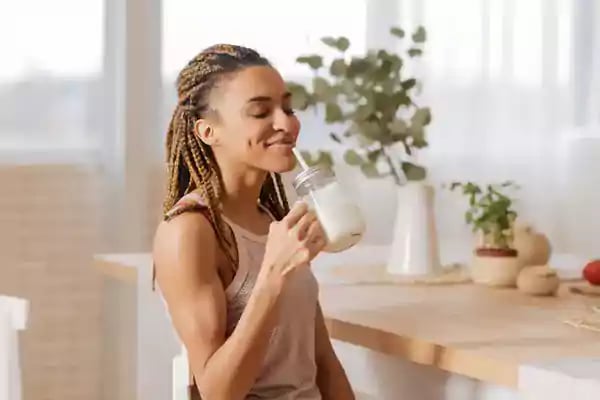 Woman drinking a protein shake.