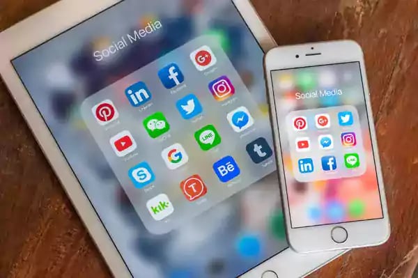 iPad and iPhone with social media icons on display.