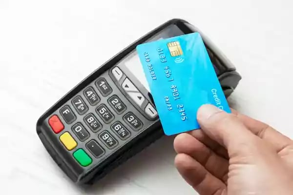 Using a credit card to make a purchase in a shop.