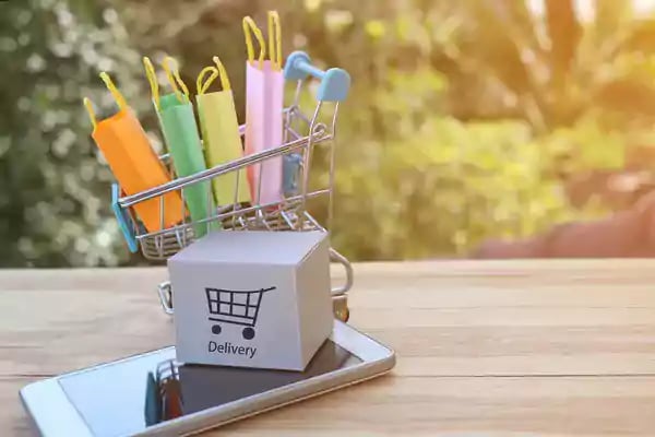 Miniature shopping cart with shopping bags