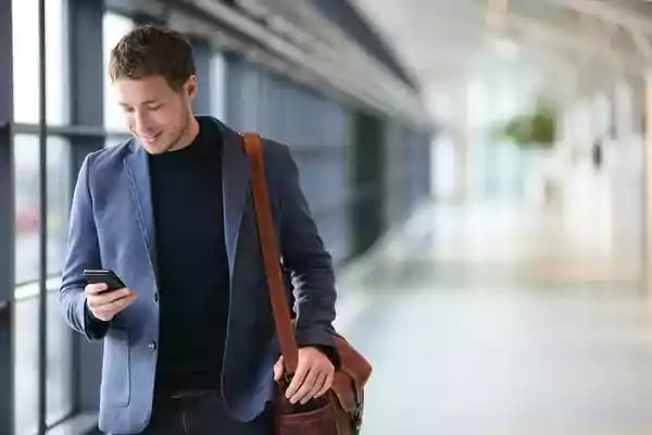 businessman-with-phone-in-airport