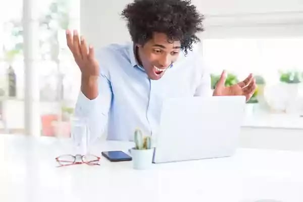 Man appearing surprised looking at this computer.