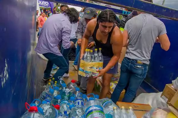 Group of aid workers organizing water bottles.