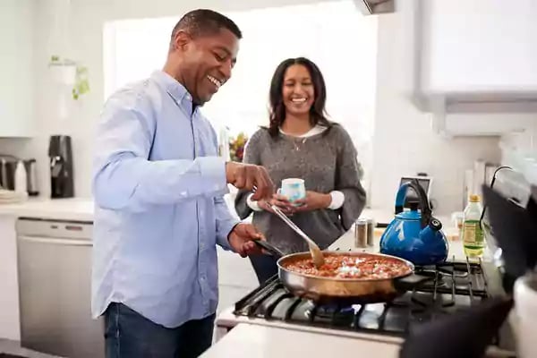 Happy couple cooking.