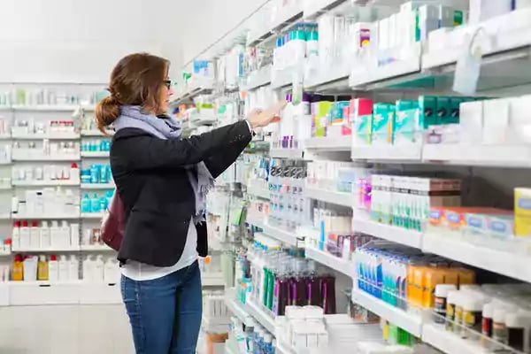 Woman shopping in a health and beauty isle.