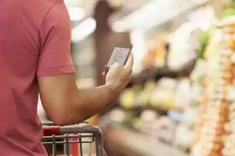 man using phone in store