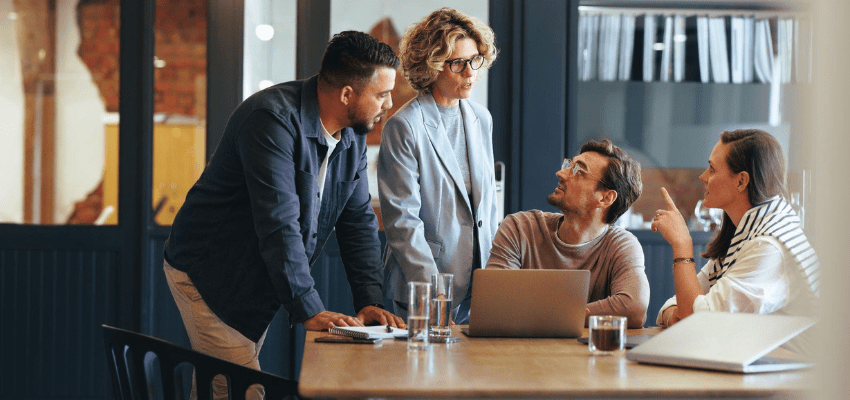 two men and two women in a meeting