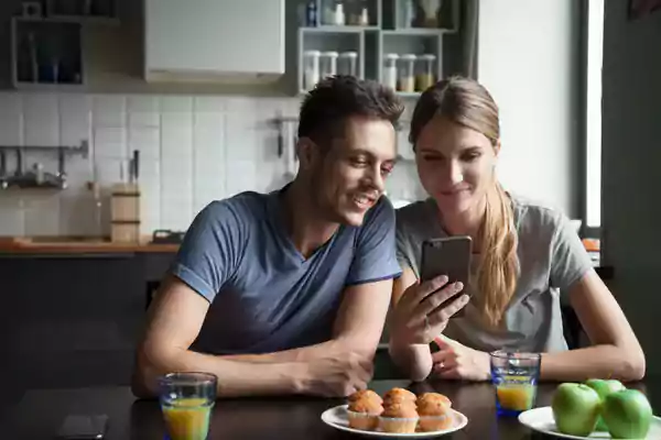 Couple looking at a cell phone together.