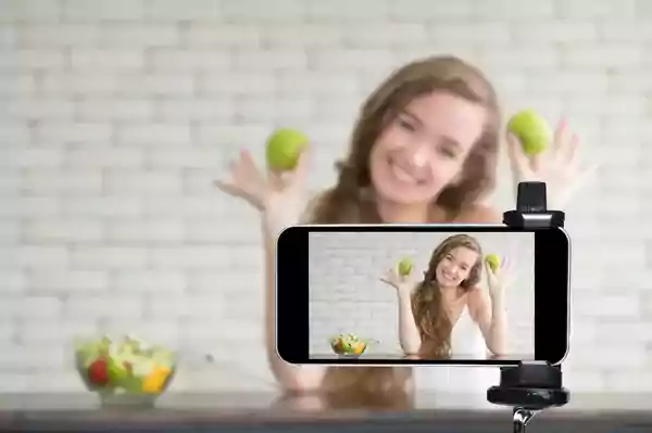 Young woman creating a TikTok video.