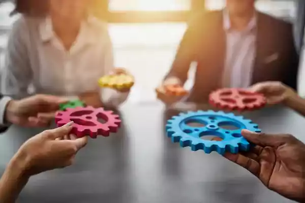Group sitting in a circle holding gears.