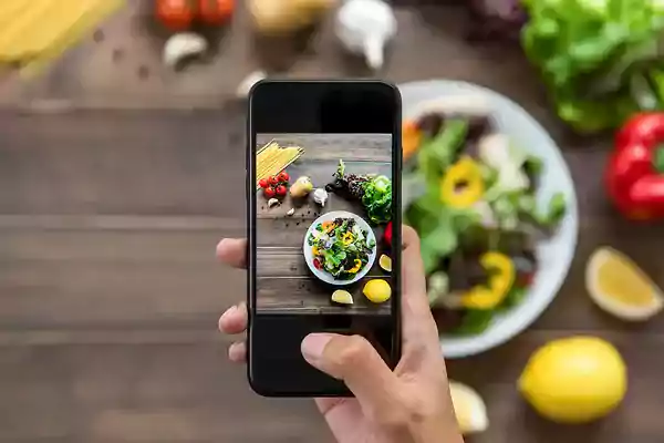 Taking a photo of a salad.