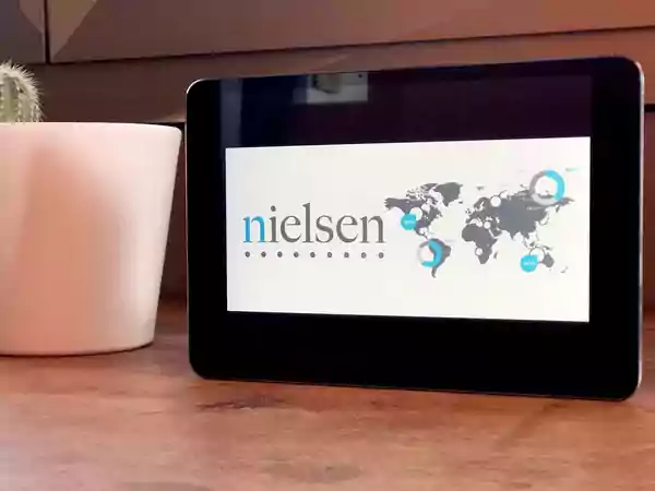 Tablet with Nielsen home page displayed.