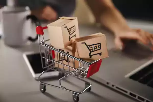 Miniature shopping cart with small cardboard boxes