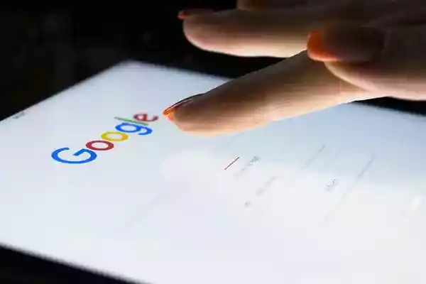 Person using a tablet to search Google.