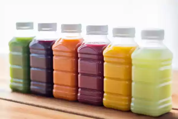 Clear plastic jugs with colored liquids.